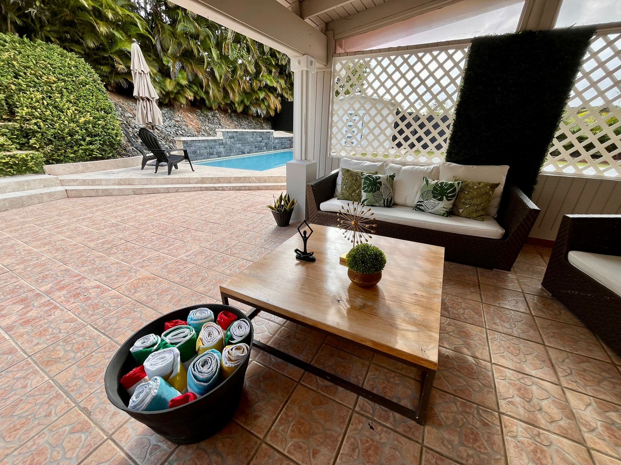 Pool area with colorful towels and lounge chairs