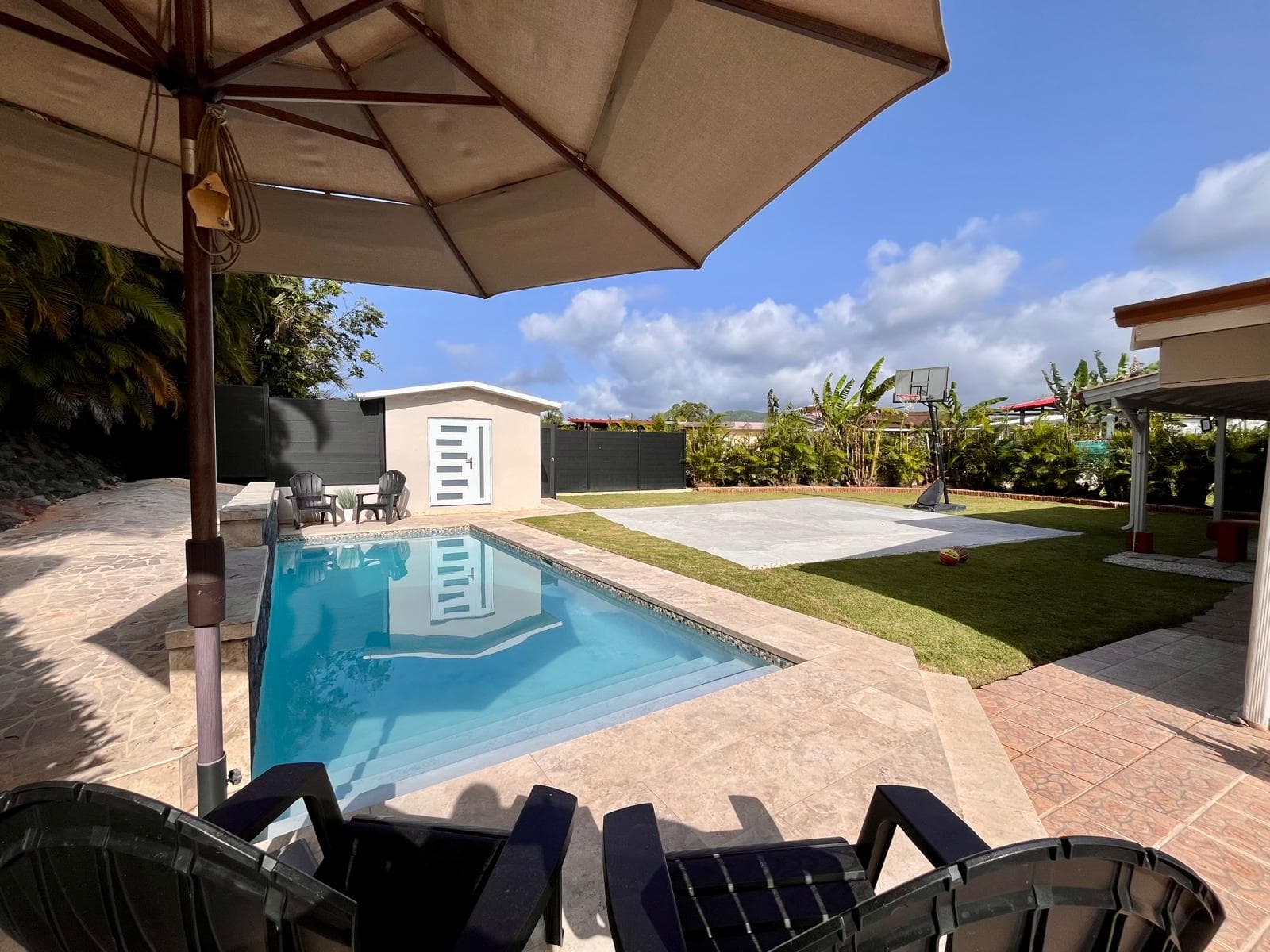 Pool area with umbrella and Basketball court